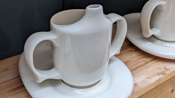 A row of ceramic two-handled cups
